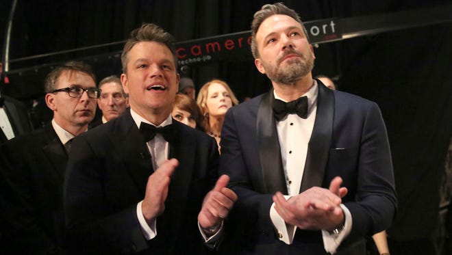 Matt Damon, left, and Ben Affleck backstage at the Oscars.