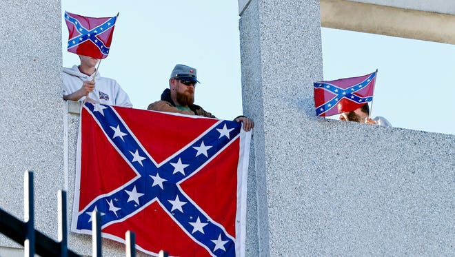 Michael Adams Jr., Tim Arnold and Dustin Smith fly the Confederate Flag outside to Bon Secours Wellness Arena before second round of the 2017 NCAA tournament game between Arkansas and North Carolina.