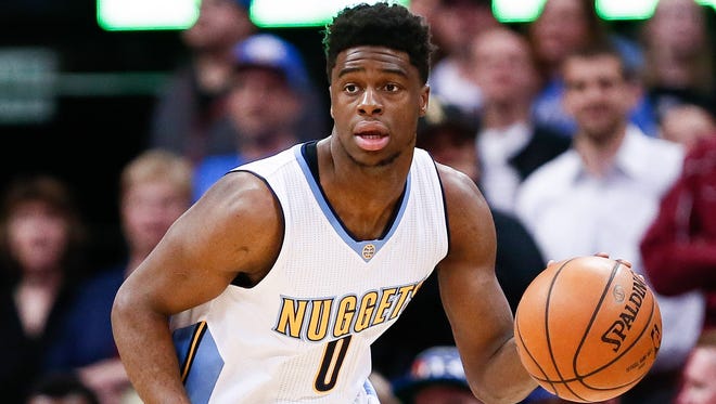Emmanuel Mudiay dribbles the ball up court in the first quarter against the Oklahoma City Thunder at the Pepsi Center.