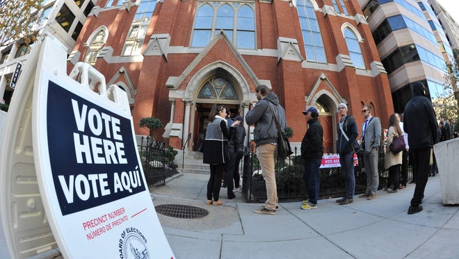 People crowd a side walk in downtown Washington, D.C. waiting to enter a church, turned polling station on Tuesday.