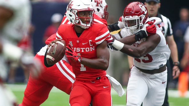 Houston Cougars quarterback Greg Ward Jr. (1) looks for an open receiver during the second quarter against the Oklahoma Sooners at NRG Stadium.