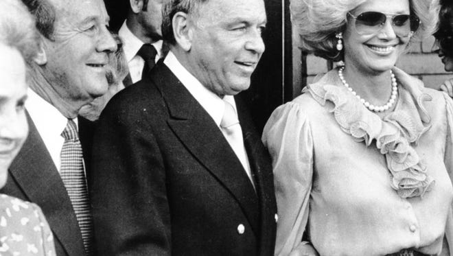 The late Ambassador Leonard Firestone accompanies Frank and Barbara Sinatra as they leave the Susan Ford-Charles Vance wedding at St. Margaret's Episcopal Church in Palm Desert in 1979.