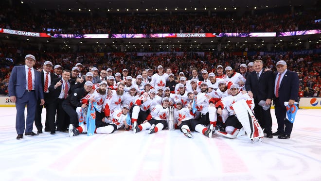 Team Canada players pose for a team photo after defeating Team Europe to win the World Cup of Hockey.