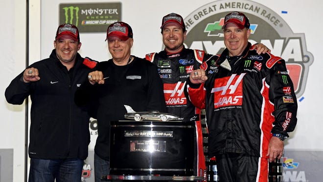 Team owners Tony Stewart and Gene Hass, NASCAR Cup Series driver Kurt Busch (41) and crew chief Tony Gibson celebrate winning the 2017 Daytona 500.
