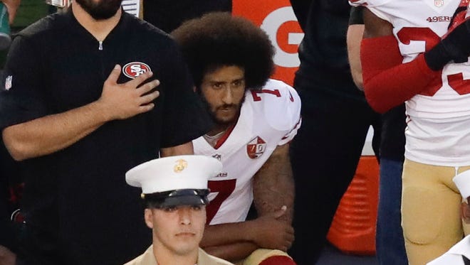 Kaepernick kneels during the national anthem before the preseason finale against the Chargers.