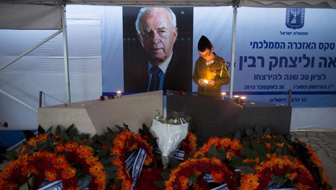 An Israeli soldier lights a candle at Yitzhak Rabin's grave in Jerusalem on Oct. 29, 2015.