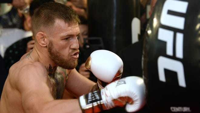 Conor McGregor hits an uppercut bag during a media workout at UFC Performance Institute in Las Vegas on Aug. 11.