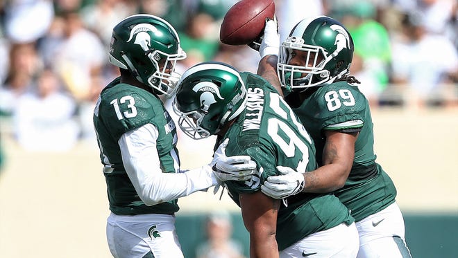 Michigan State Spartans defensive tackle Kevin Williams (92) celebrates a fumble recovery during the first quarter of a game against the Wisconsin Badgers  at Spartan Stadium.