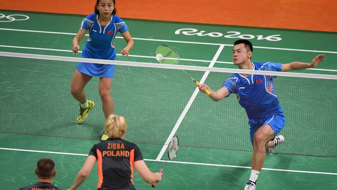 Chen Xu of Chinal plays a shot against Poland during the preliminary round in the Rio 2016 Summer Olympic Games at Riocentro - Pavilion 4.