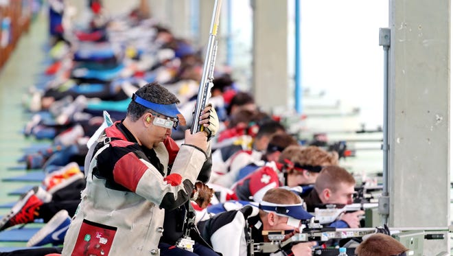Competitors shoot during the men's 50-meter prone rifle qualifications in the Rio 2016 Summer Olympic Games at Olympic Shooting Centre.