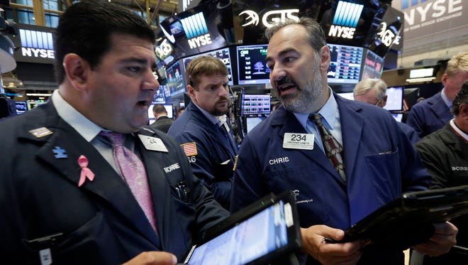 Christopher Cornette, right, works with fellow traders on the floor of the New York Stock Exchange, Thursday, Sept. 1, 2016.