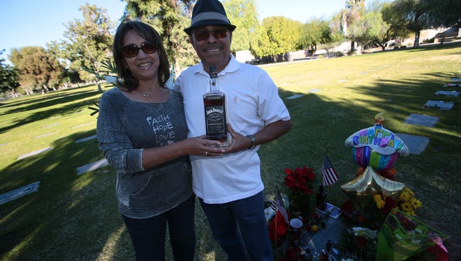 Frank Sinatra fans gather at Sinatra's grave on his 100th birthday at the Desert Memorial Park in Cathedral City on Saturday.