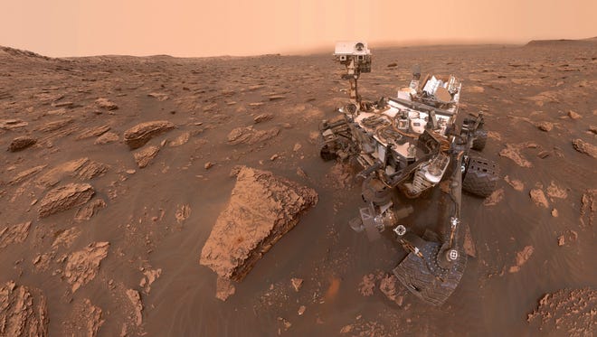 This composite image made from a series of June 15, 2018 photos shows a self-portrait of NASA's Curiosity Mars rover in the Gale Crater. The rover's arm which held the camera was positioned out of each of the dozens of shots which make up the mosaic. A dust storm has reduced sunlight and visibility at the rover's location.