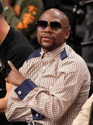 American boxer Floyd Mayweather sits courtside during the fourth quarter between the Brooklyn Nets and the New Orleans Pelicans at Barclays Center.