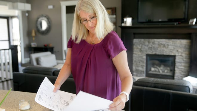 Kathy Daley looks over receipts and paperwork in her Cedar Rapids, Iowa, home that she received after an incident while vacationing in Cancun. Daley, her husband and their two teenage children traveled to Iberostar Cancun about 28 miles north of the Iberostar Paraíso del Mar in March 2016. Her husband and some other people drank a couple of shots of tequila and went with their son around the corner to another pool. Kathy and the girls stayed at the swim-up bar and the bartender made Kathy a different drink since she didn't want a shot. She had not been drinking alcohol and was not drunk. She took a few sips and blacked out. The next thing she remembers is being in a hospital in Cancun. They said she was very drunk and demanded cash from her husband in order to treat her.