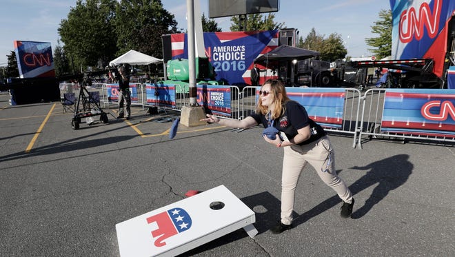 A woman plays a beanbag game outside a student center several hours before the start of the first presidential debate between Hillary Clinton and Donald Trump at Hofstra University.