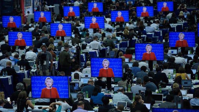 Democratic presidential nominee Hillary Clinton is seen on multiple screens speaking during the first presidential debate at Hofstra University.