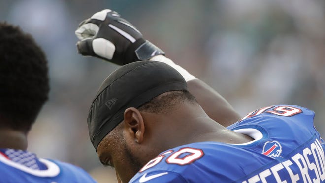Buffalo Bills offensive tackle Cameron Jefferson raises his fist during the national anthem before a preseason game against the Philadelphia Eagles in Philadelphia. Jefferson says he gained the courage to raise his fist in protest during the anthem once he saw Chris Long hug Eagles teammate Malcolm Jenkins on the opposite sideline on Thursday.