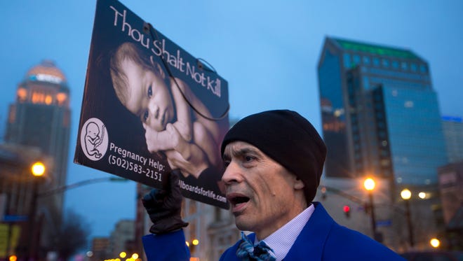 Dominic Monreal protested outside the EMW Women's Surgical Center on Market Street, in Louisville. the facility is the last abortion clinic in Kentucky. Feb. 11, 2017.
