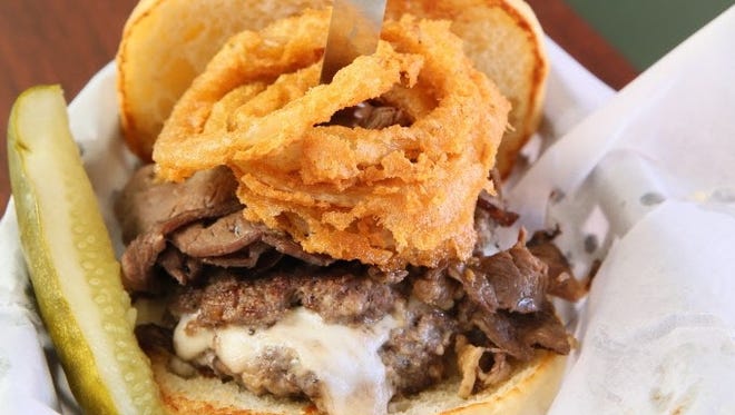 The Beast, a mozzarella-stuffed burger topped with prime rib and onion rings, is one of the burgers at Crafty Cow, a craft beer bar in Oconomowoc. A second location will open in half of Bumstead Provisions, the sandwich shop at 2671 S. Kinnickinnic Ave.