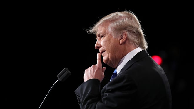 Republican presidential nominee Donald Trump looks on during the presidential debate at Hofstra University.