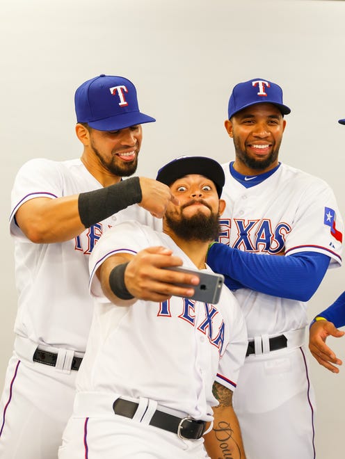 Rangers second baseman Rougned Odor (center) takes a selfie photo with pitcher Martin Perez (left) and shortstop Elvis Andrus