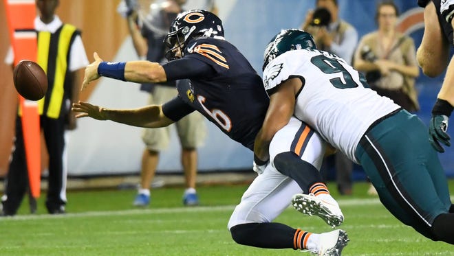 Bears quarterback Jay Cutler (6) fumbles the ball after a big hit from Eagles defender Destiny Vaeao during the second half.