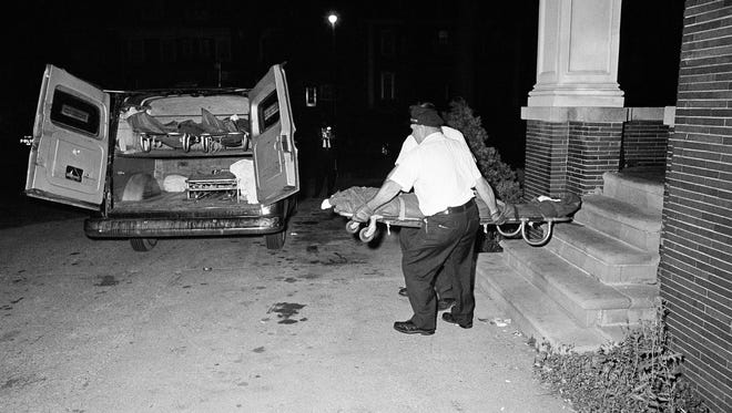 The bodies of three shooting victims are removed from the Algiers Motel in midtown Detroit, July 26, 1967. The three black men were found shot to death in a room of the motel.