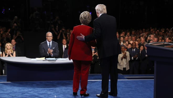Democratic presidential nominee Hillary Clinton takes the stage with Republican presidential nominee Donald Trump during the Presidential Debate at Hofstra University.