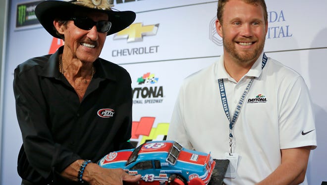 Chip Wile (right), president of Daytona International Speedway, presents Richard Petty with an 80th birthday cake with the iconic No. 43 car on June 30, 2017.