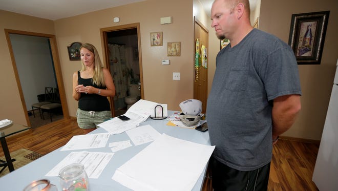 Heidi Sorrem, left, stands near the receipts and paperwork as she talked about her and her husband's, Corey Sorrem vacation trip to Mexico.