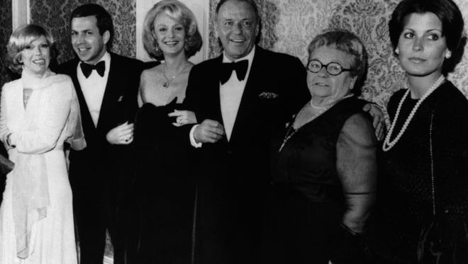 Actor Frank Sinatra, center, poses with his family during an awards presentation, from left, daughter Nancy Sinatra, son Frank Sinatra Jr., Barbara Sinatra, mother Dolly Sinatra, and daughter Tina Sinatra in Los Angeles on November 19, 1976.