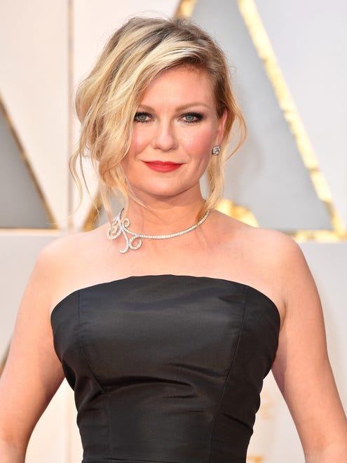 Kirsten Dunst married her regal attire with unstructured, rocker hair. We are loving the contrast. The updo was styled by Adir Abergel.