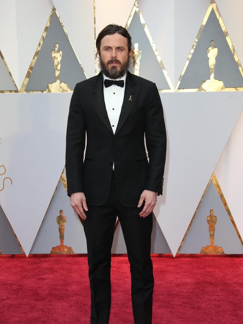Casey Affleck's mountain man looks clean up nicely in Louis Vuitton .