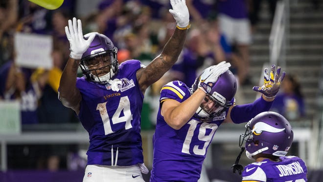 Vikings receiver Stefon Diggs (14) celebrates his touchdown catch with Adam Thielen (19) during the second half against the Packers.