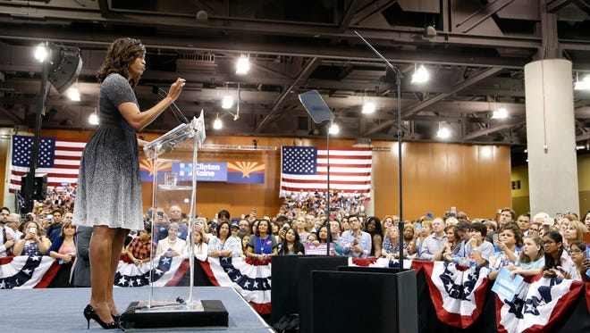 Obama addresses the crowd at a Clinton rally on Oct. 20, 2016, in Phoenix. She spoke about Trump as "living high up in a tower in a world of exclusive clubs."