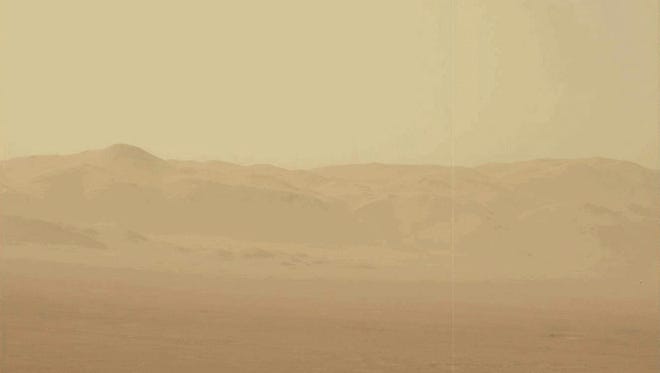 An undated handout photo made available by NASA on June 21, 2018 shows a snap photo captured by NASA's Curiosity Rover in June 2018, using its Mast Camera (Mastcam), of intensifying haziness in the surface of Mars, caused by a massive dust storm. The rover was standing inside Gale Crater looking out to the crater rim.