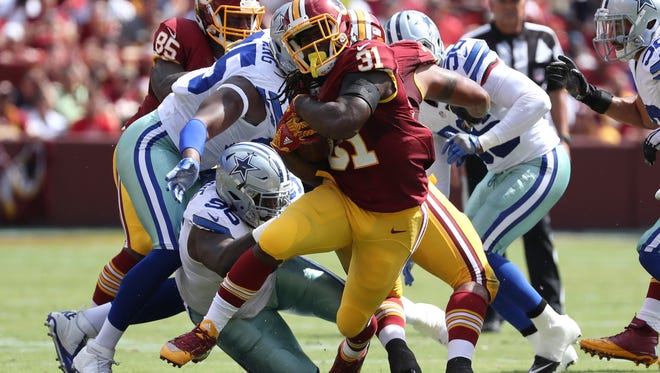 Redskins running back Matt Jones (31) carries during the first half against the Cowboys.