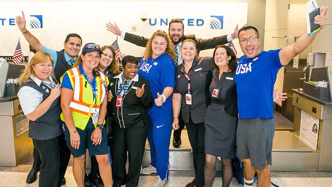 United employees pose with some members of the U.S. Olympic team at Houston Bush Intercontinental on Aug. 3, 2016.