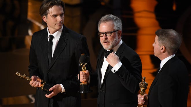 Byron Howard, left, Rich Moore and Clark Spencer, right, accept the Oscar for best animated feature film for 'Zootopia' during the 89th Academy Awards.