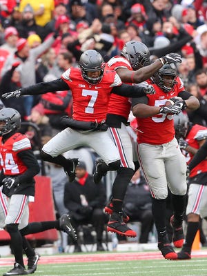 Ohio State Buckeyes defensive tackle Davon Hamilton (53) is congratulated by safety Damon Webb (7) and defensive end Jalyn Holmes (center) following his fumble recovery at the goal line during the third quarter.