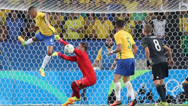 Brazil defender Marquinhos (4) tries to get the ball past Germany goalkeeper Timo Horn (1) in the men's gold medal match during the Rio 2016 Summer Olympic Games at Maracana.