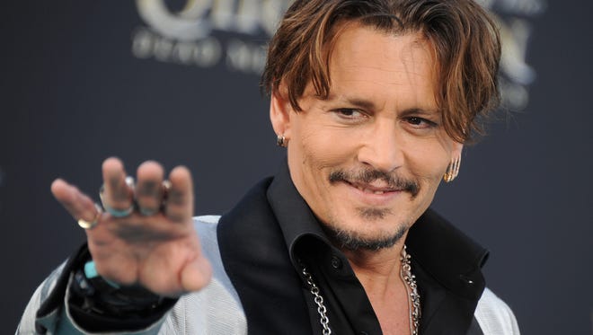 Johnny Depp didn't spend too much time on the carpet, but he did wave.