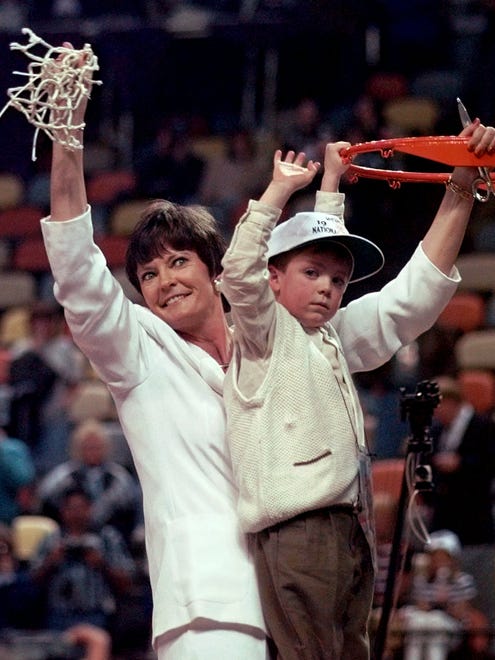 Summitt holds up the net with her son Tyler after the Lady Vols defeated Old Dominion 1997 NCAA championship in Cincinnati.