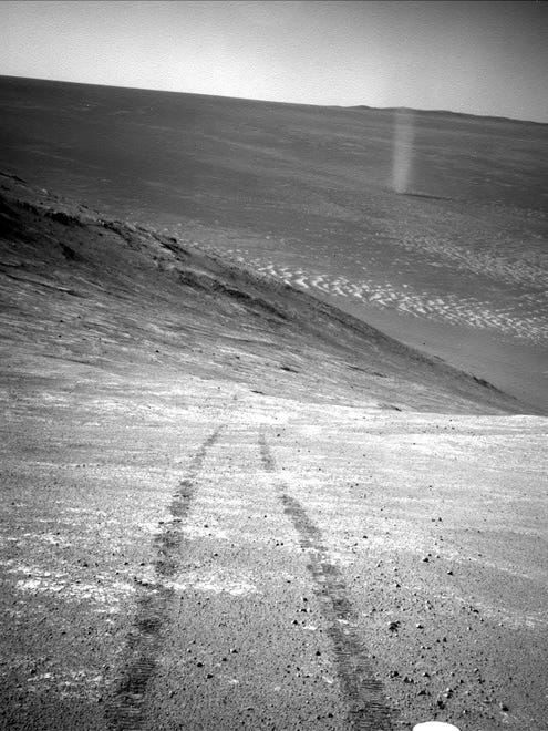 NASA's Mars Exploration Rover Opportunity recorded this image of a Martian dust devil twisting through the valley below.