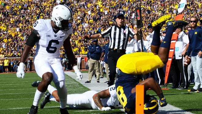 Michigan Wolverines fullback Khalid Hill (80) is knocked out of bounds in the first quarter by Penn State Nittany Lions safety Malik Golden (6) and safety Marcus Allen (2) at Michigan Stadium.
