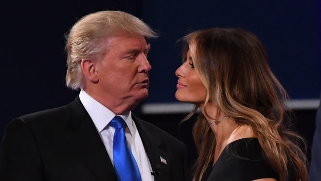 Republican presidential candidate Donald Trump greets his wife Melania on stage after the first presidential debate at Hofstra University.