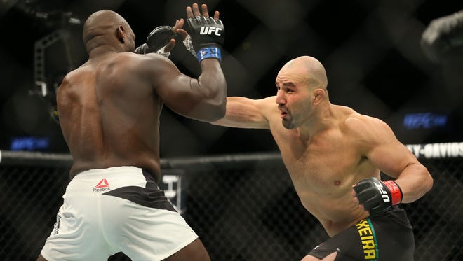 Glover Teixeira (red gloves) fights Jared Cannonier (blue gloves) during UFC 208 at Barclays Center.