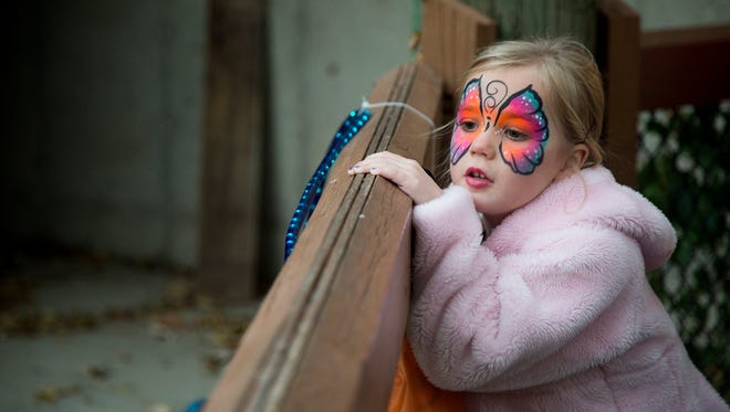 Isabella Bieker, 4, of Des Moines, checks out some animals while trick-or-treating during Night Eyes at Blank Park Zoo in Des Moines, Iowa, Thursday, Oct. 15, 2015.