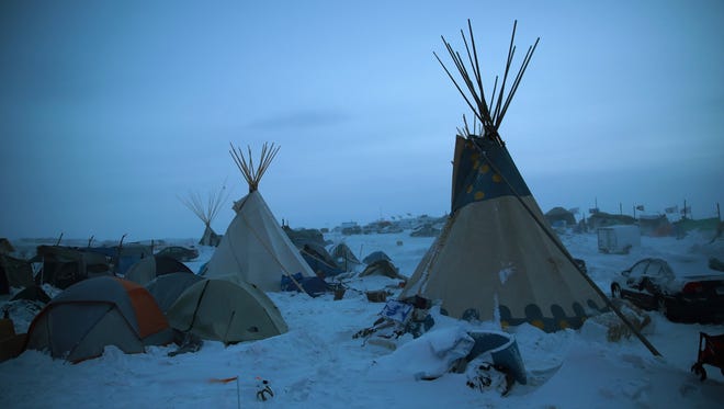 Activists at Oceti Sakowin near the Standing Rock Sioux Reservation brace for sub-zero temperatures expected overnight on Dec. 6, 2016, outside Cannon Ball, N.D.